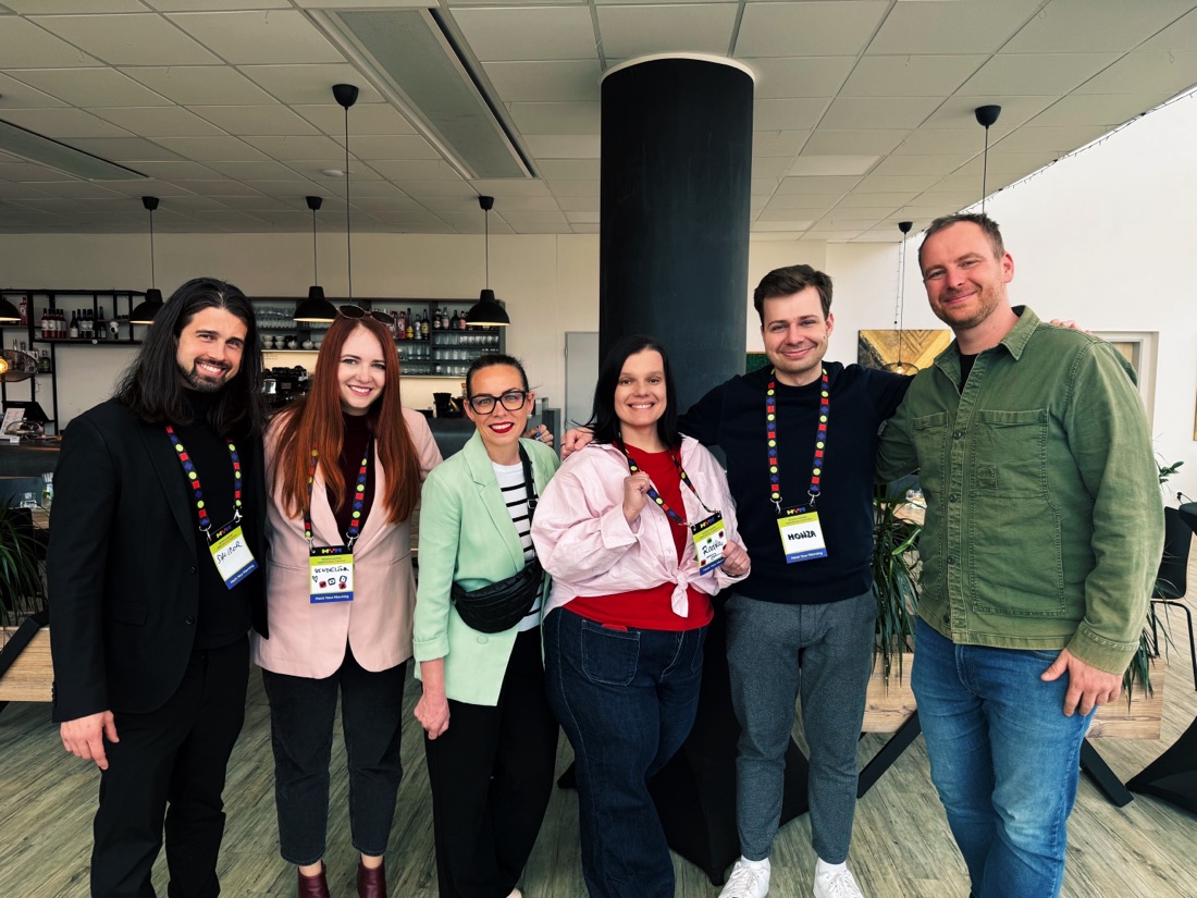 Attendees with conference lanyards at a ČERNÁ.AI event